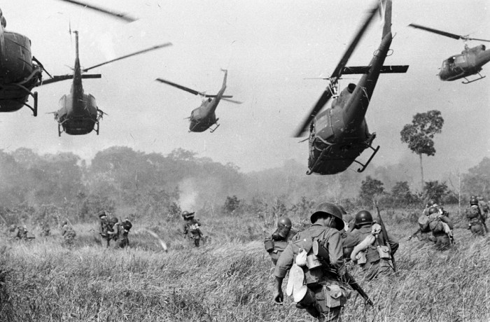Hovering U.S. Army helicopters pour machine gun fire into a tree line to cover the advance of South Vietnamese ground troops in an attack on a Viet Cong camp 18 miles north of Tay Ninh, northwest of Saigon near the Cambodian border, in Vietnam on March 1965. (AP Photo/Horst Faas) 