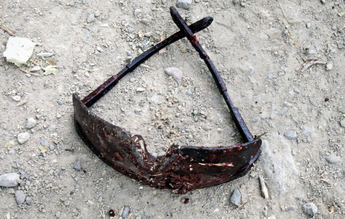 A pair of bloody sunglasses lie on the ground after an IED exploded injuring two US Army soldiers just outside Combat Outpost Nolen in the Arghandab Valley north of Kandahar July 30, 2010. (REUTERS/Bob Strong)